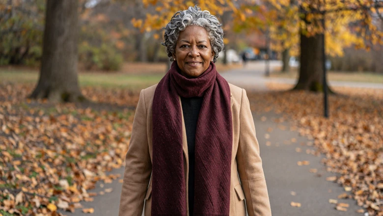 Warm smiling woman walking through an autumn park representing OurTime's genuine senior dating community
